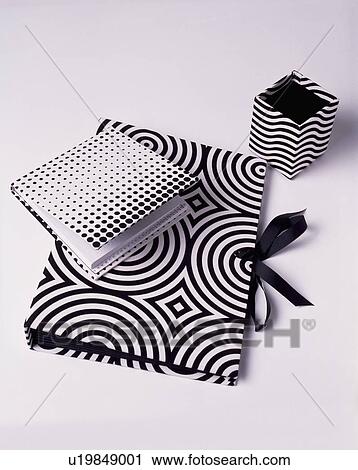 Close-up of black+white Op-Art print notebook with folder and small box View Large Photo Image Stock Image - Close-up of black+white Op-Art print notebook with folder and small box. Fotosearch