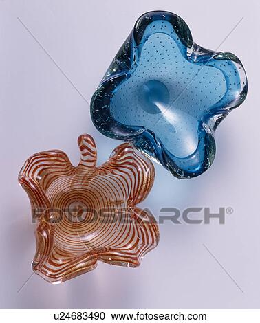 Stock Image - Close-up of blue and brown heavy glass dishes viewed from above. Fotosearch
