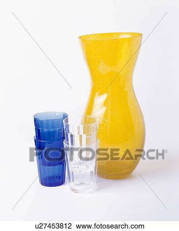 Close-up of blue and clear glasses with tall yellow glass vase View Large Photo Image Stock Image - Close-up of blue and clear glasses with tall yellow glass vase. Fotosearch