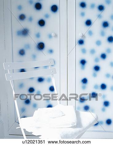 Close-up of blue chair against hand-painted spotted wardrobe View Large Photo Image Stock Image - Close-up of blue chair against hand-painted spotted wardrobe. Fotosearch