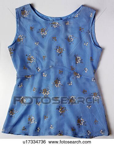 Stock Photograph - Close-up of blue cotton top with floral beading. Fotosearch