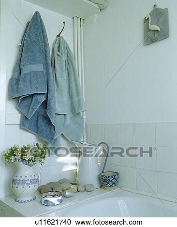 Close-up of blue towels above jugs in cottage bathroom View Large Photo Image Stock Image - Close-up of blue towels above jugs in cottage bathroom. Fotosearch