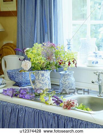 Close-up of blue+white jugs of fresh flowers beside kitchen sink View Large Photo Image Stock Photo - Close-up of blue+white jugs of fresh flowers beside kitchen sink. Fotosearch
