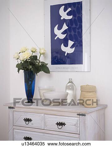 Close-up of blue+white picture on wall above white chest-of-drawers View Large Photo Image Stock Photography - Close-up of blue+white picture on wall above white chest-of-drawers. Fotosearch
