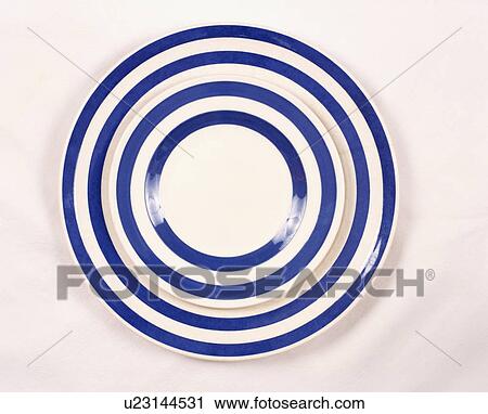 Stock Image - Close-up of blue+white striped plates. Fotosearch