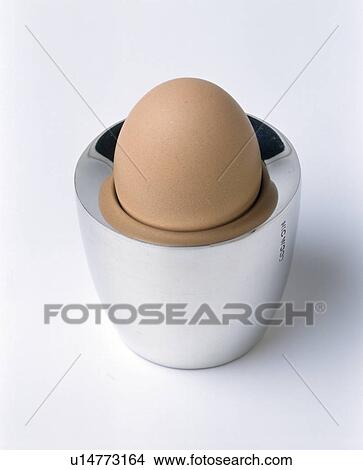 Close-up of boiled egg in modern silver egg-cup View Large Photo Image Picture - Close-up of boiled egg in modern silver egg-cup. Fotosearch