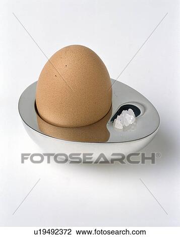 Close-up of boiled egg in modern silver egg-cup View Large Photo Image Stock Image - Close-up of boiled egg in modern silver egg-cup . Fotosearch