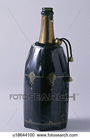 Stock Image - Close-up of bottle of champagne in black plastic cooler. Fotosearch