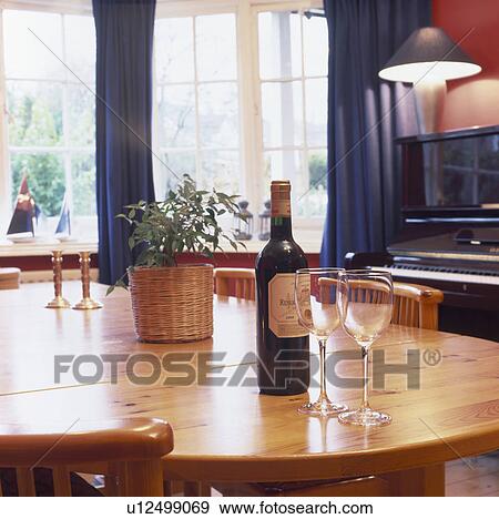 Close-up of bottle of wine and wine-glasses on varnished pine table View Large Photo Image Stock Photo - Close-up of bottle of wine and wine-glasses on varnished pine table. Fotosearch