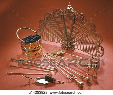 Close-up of brass coal-scuttle and fan-shaped fireguard with fire tools View Large Photo Image Stock Photo - Close-up of brass coal-scuttle and fan-shaped fireguard with fire tools. Fotosearch