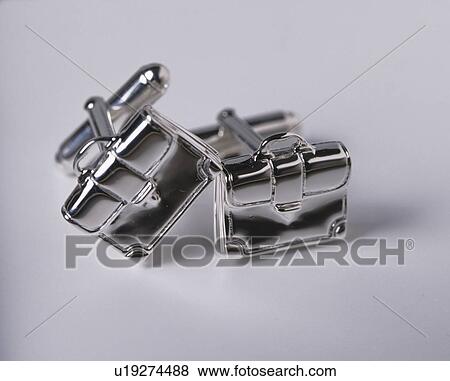 Stock Photo - Close-up of briefcase-shaped silver cuff-links. Fotosearch
