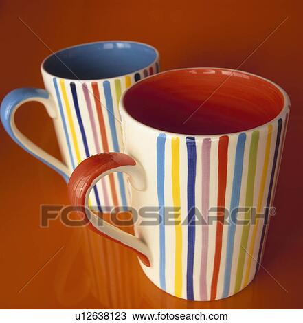 Stock Image - Close-up of brightly-coloured striped mugs. Fotosearch