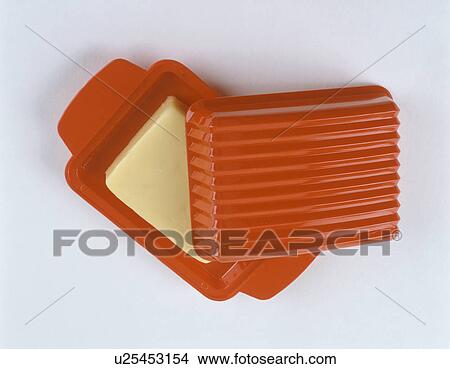 Picture - Close-up of butter in red plastic butter dish. Fotosearch