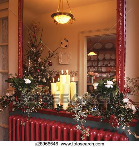 Close-up of candles and Christmas foliage decoration in front of mirror View Large Photo Image Stock Photograph - Close-up of candles and Christmas foliage decoration in front of mirror. Fotosearch