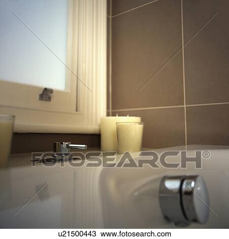 Close-up of candles in glass jars on bath below window View Large Photo Image Stock Image - Close-up of candles in glass jars on bath below window. Fotosearch
