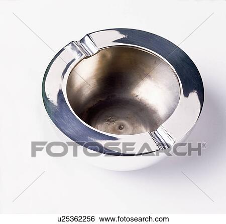 Stock Photograph - Close-up of circular stainless-steel ashtray. Fotosearch