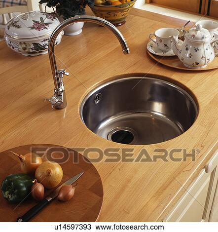 Close-up of circular stainlesss steel basin and mixer tap in wooden worktop View Large Photo Image Stock Image - Close-up of circular stainlesss steel basin and mixer tap in wooden worktop. Fotosearch