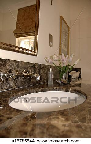 Close-up of circular underset basin in marble-topped vanity unit View Large Photo Image Picture - Close-up of circular underset basin in marble-topped vanity unit. Fotosearch