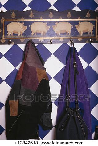 Stock Photo - Close-up of clothes on peg in blue and white checked hall. Fotosearch
