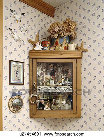 Close-up of collection of children's thirties nautical toys and ornaments in glass-fronted pine wall-cupboard View Large Photo Image Stock Image - Close-up of collection of children's thirties nautical toys and ornaments in glass-fronted pine wall-cupboard. Fotosearch
