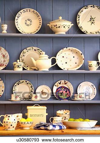 Close-up of collection of pottery plates and dishes on blue shelves View Large Photo Image Stock Image - Close-up of collection of pottery plates and dishes on blue shelves. Fotosearch