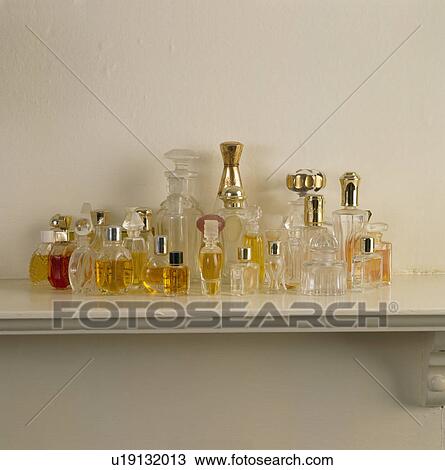 Close-up of collection of silver-topped perfume bottles View Large Photo Image Stock Image - Close-up of collection of silver-topped perfume bottles. Fotosearch