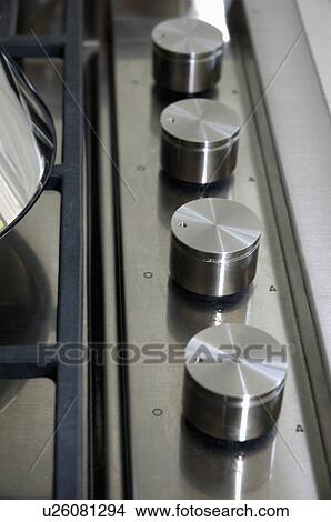 Close-up of control switches on stainless steel hob View Large Photo Image Picture - Close-up of control switches on stainless steel hob. Fotosearch