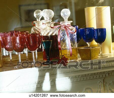 Close-up of cranberry red wine-glasses on mantelpiece with cut-glass decanters and blue wine-glasses View Large Photo Image Stock Photo - Close-up of cranberry red wine-glasses on mantelpiece with cut-glass decanters and blue wine-glasses. Fotosearch