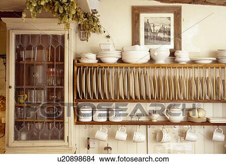 Close-up of cream bowls on wooden plate rack View Large Photo Image Picture - Close-up of cream bowls on wooden plate rack. Fotosearch