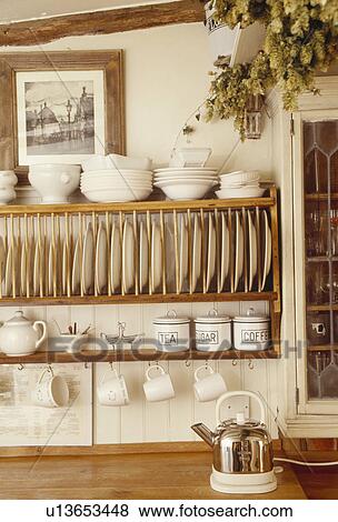 Close-up of cream bowls on wooden plate rack View Large Photo Image Stock Photo - Close-up of cream bowls on wooden plate rack. Fotosearch