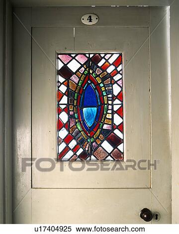 Close Up Of Cream Painted Front Door With Victorian Stained Glass Panel Stock Photography