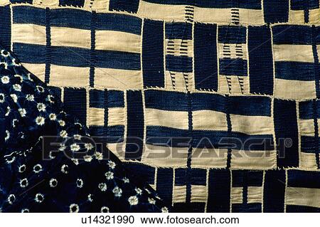 Stock Image - Close-up of cream+black ethnic-style fabric with spotted black fabric. Fotosearch