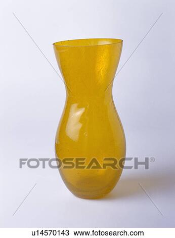 Close-up of curved amber-yellow glass vase View Large Photo Image Stock Image - Close-up of curved amber-yellow glass vase. Fotosearch