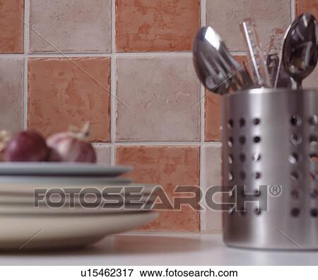 Close-up of cutlery in steel canister in front of pink+white tiled wall View Large Photo Image Stock Photo - Close-up of cutlery in steel canister in front of pink+white tiled wall. Fotosearch