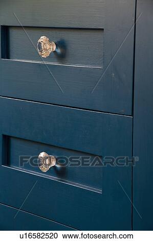 Close Up Of Dark Grey Kitchen Drawers With Glass Handles Stock