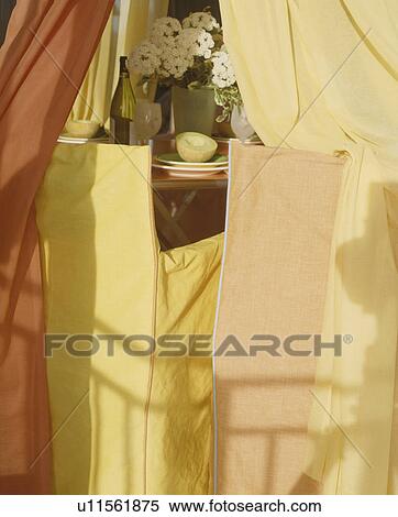 Stock Photography - Close-up of director's chairs with yellow and cream loosecovers. Fotosearch