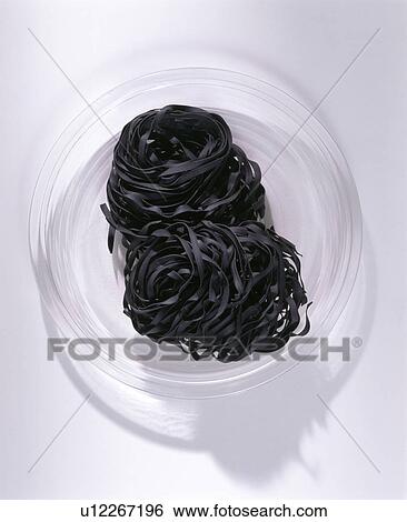 Close-up of dried black pasta in glass dish View Large Photo Image Stock Photograph - Close-up of dried black pasta in glass dish. Fotosearch