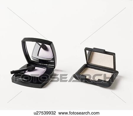 Stock Image - Close-up of eye-shadow in black plastic containers. Fotosearch