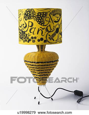 Stock Photo - Close-up of fifties yellow wicker lamp with yellow and black Spanish lampshade. Fotosearch