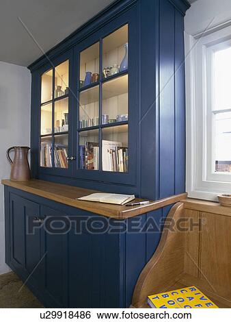 Close-up of fitted blue kitchen dresser with lighted shelves View Large Photo Image Stock Photograph - Close-up of fitted blue kitchen dresser with lighted shelves. Fotosearch