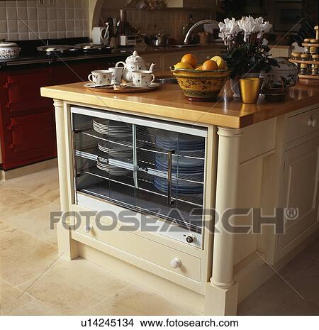 Picture - Close-up of fitted plate-warmer in modern kitchen. Fotosearch