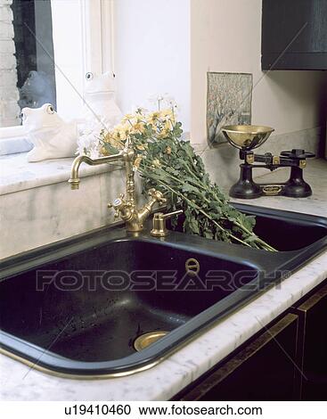 Close-up of flowers in black double sink and old weighing scales View Large Photo Image Stock Image - Close-up of flowers in black double sink and old weighing scales. Fotosearch