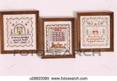 Stock Photography - Close-up of framed cross-stitch samplers. Fotosearch