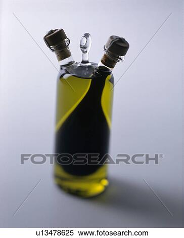 Close-up of glass bottle of Extra-Virgin olive oil with two spouts View Large Photo Image Stock Photography - Close-up of glass bottle of Extra-Virgin olive oil with two spouts. Fotosearch