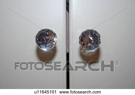 Close-up of glass handles on cupboard doors View Large Photo Image Stock Image - Close-up of glass handles on cupboard doors. Fotosearch