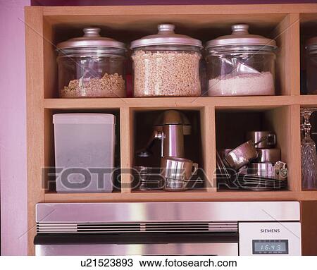 Close-up of glass storage jars and steel pans on wooden cube shelving View Large Photo Image Stock Image - Close-up of glass storage jars and steel pans on wooden cube shelving . Fotosearch