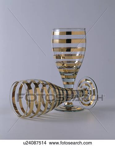 Picture - Close-up of gold-striped wine-glasses. Fotosearch