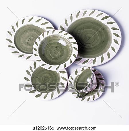 Stock Photography - Close-up of green and white pottery plates with cup and saucer. Fotosearch