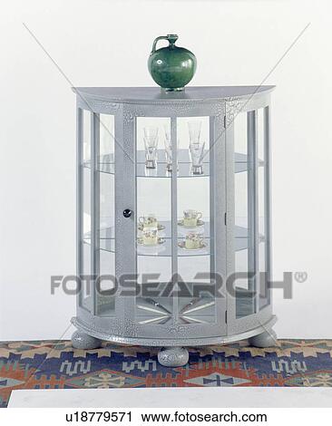 Stock Image - Close-up of grey thirties-style semi-circular glazed cupboard. Fotosearch