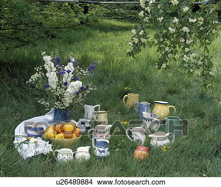 Close-up of group of ceramic and pottery jugs in long grass of summer garden View Large Photo Image Picture - Close-up of group of ceramic and pottery jugs in long grass of summer garden. Fotosearch